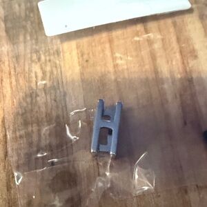 Silver letter “H” keep collective charm